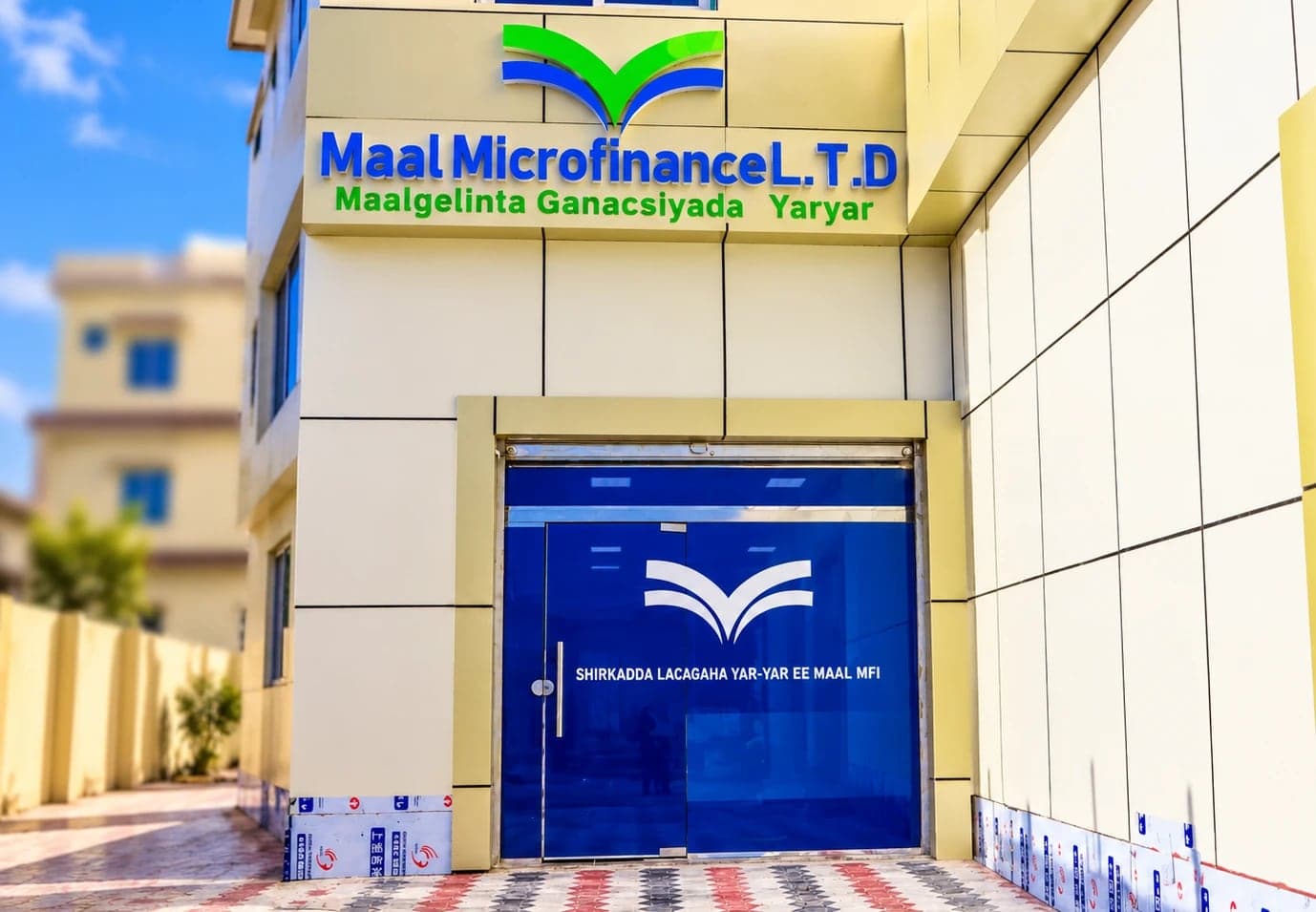 Entrance of the Maal Microfinance L.T.D office with the Maal logo above the door